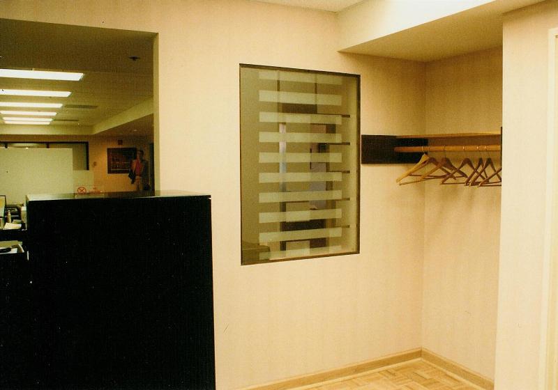 It is difficult to see in this photograph, but the frosted panel by the coat rac