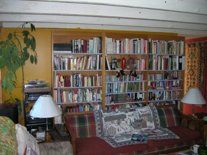View of living area with exposed beam ceiling.