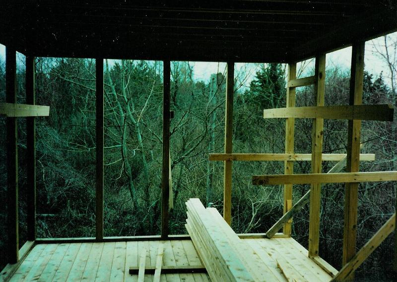 The dining porch, which feels suspended in the yard, jutting toward the trees at