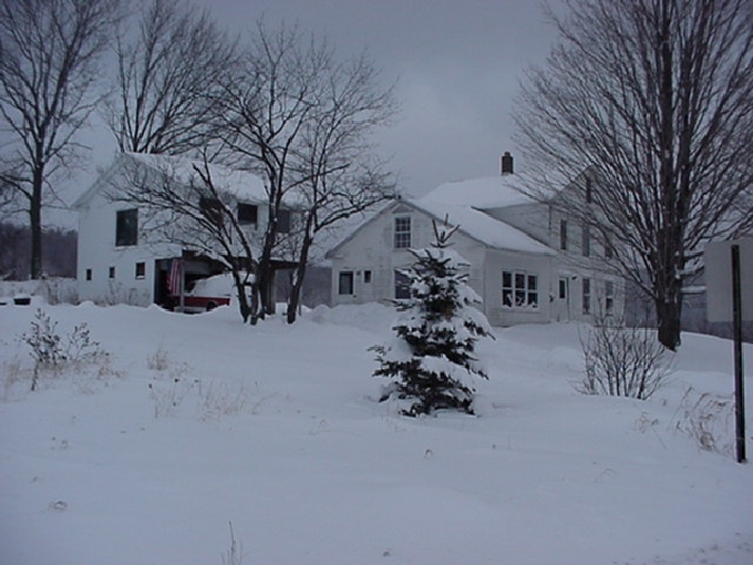 Road view of the garage on a snowy day.