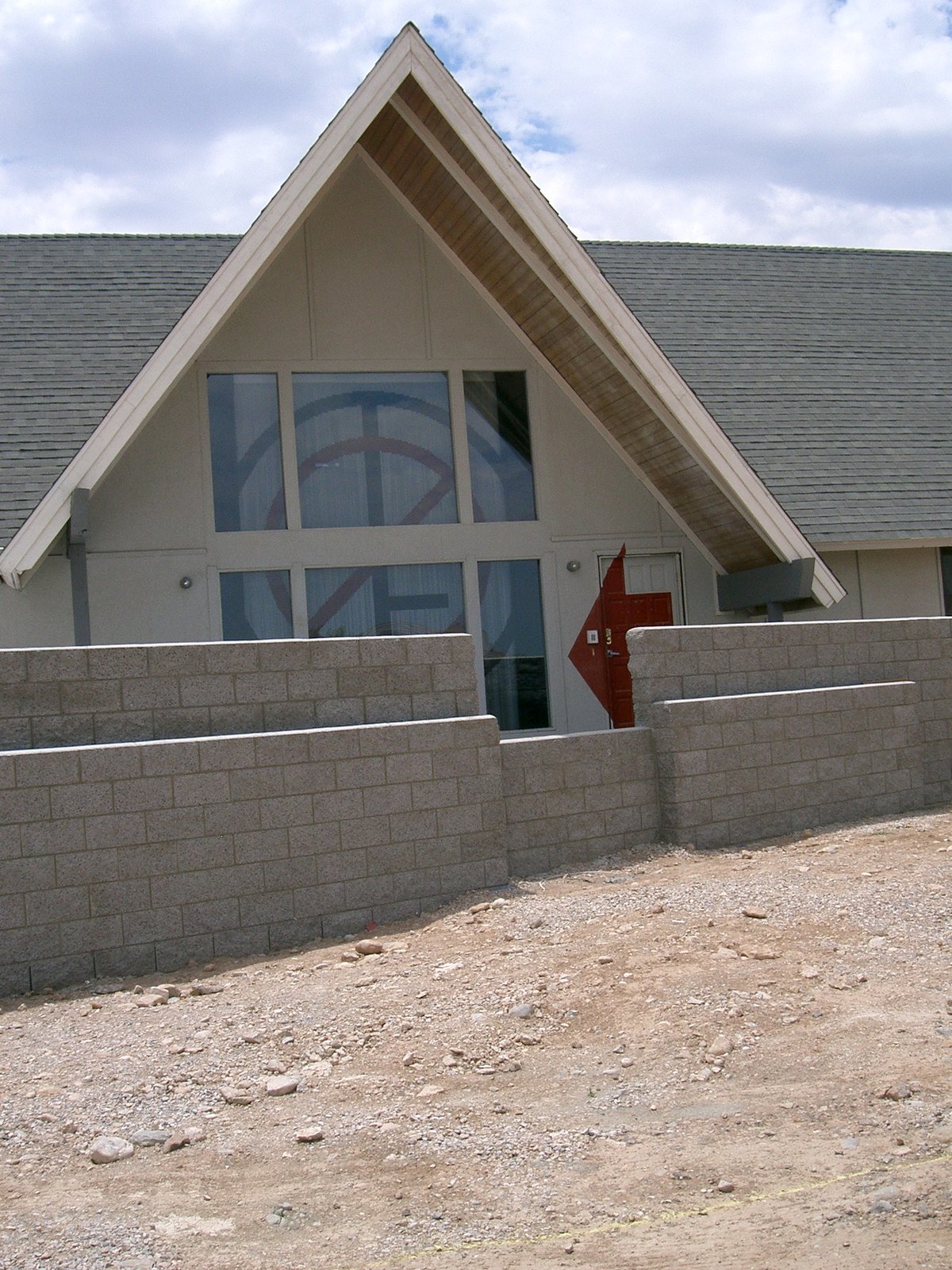 The two story, north-facing window of the existing living room with the new chai