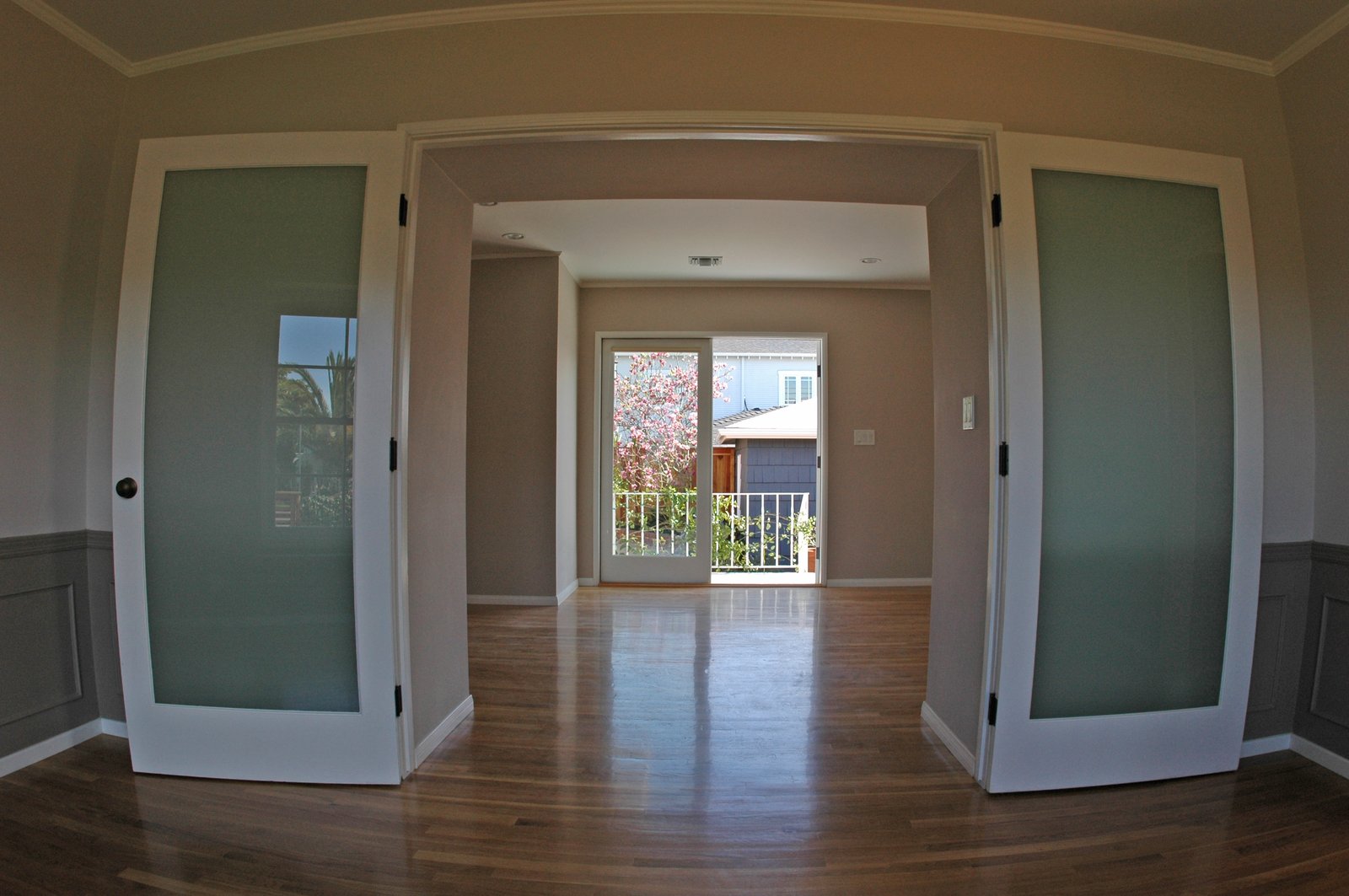 Looking through the frosted doors of the dining room, through the family room an