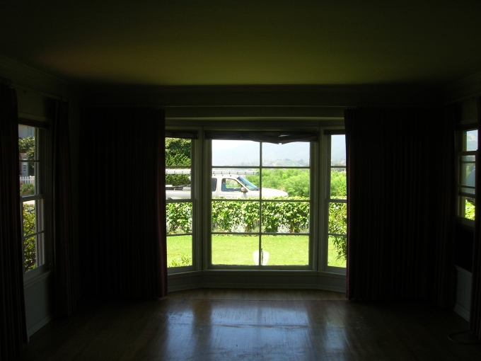 Looking out to the front yard from the Living Room. The eight panel window was r